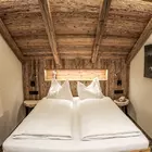 Zierbalken im Schlafzimmer aus Altholz als Deckenverkledung